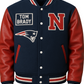 Navy and red letterman jacket with 'Tom Brady' and 'N' logos on a beige background