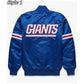 Back of New York Giants satin varsity jacket featuring large team logo and striped ribbed hem
