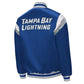 Back of NHL Tampa Bay Lightning satin varsity jacket in blue colour featuring large team logo and striped ribbed hem